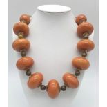 An Amber Resin Large Rondelle Necklace. 48cm