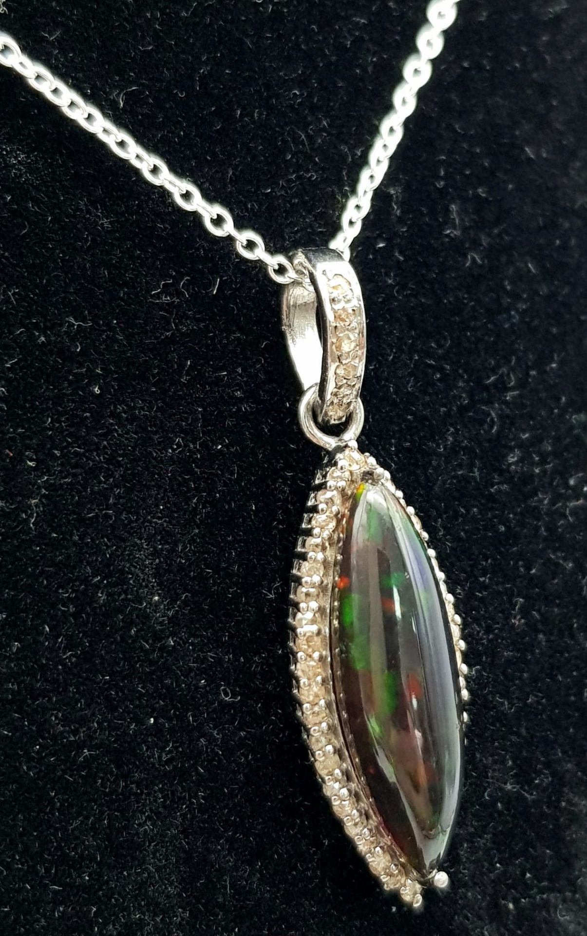 A Marquise Cut Black Opal Pendant with Diamond Surround on 925 Silver and a Silver Chain. 3.75ct