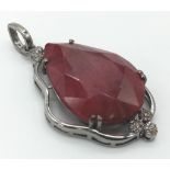 A 55.95ct Ruby Teardrop Pendant with 0.45ctw of Diamond Accents. 17.5g total weight. 5.5cm. Comes