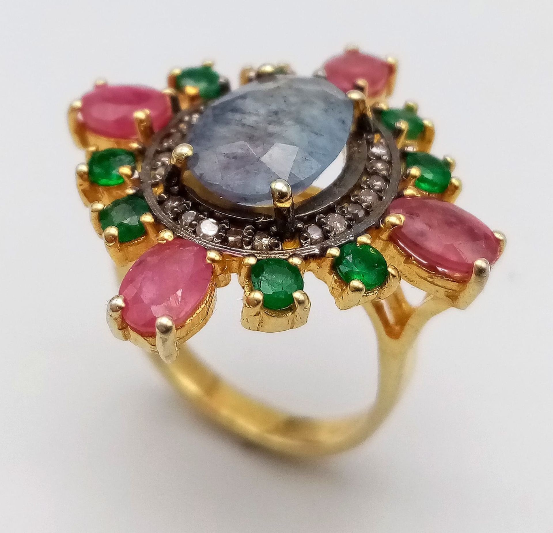 A Blue Sapphire, Ruby, Emerald and Diamond Ring set in Gold Plated 925 silver. Weight - 7.40g.