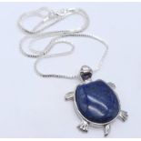 A Lapis Lazuli Turtle Pendant on a White Metal Necklace. 4cm and 46cm.