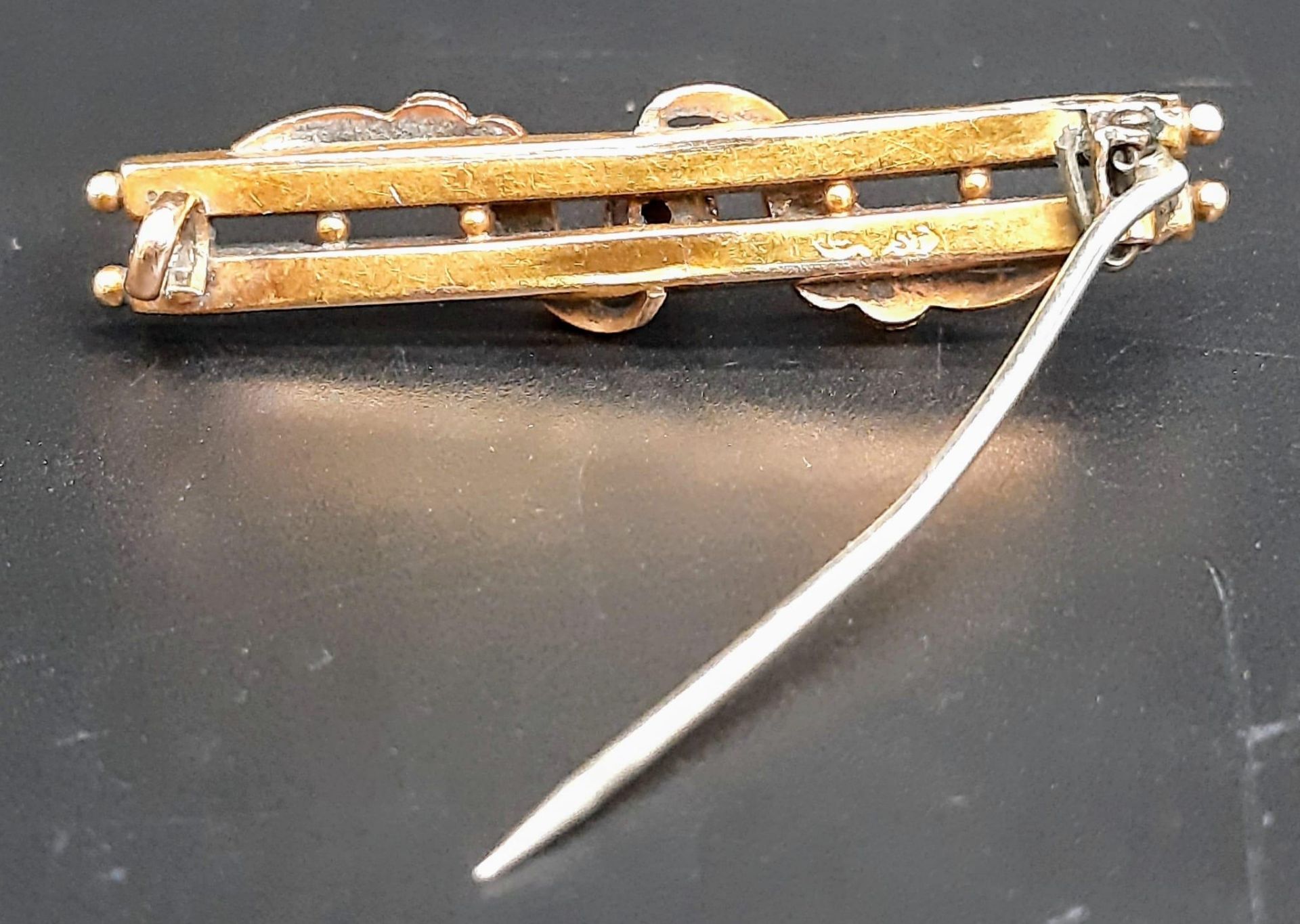 An Antique 15K Rose Gold Bar Brooch. Ornate decoration. Pin has been replaced. 4.5cm length. 3g - Image 2 of 4
