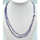 A 100ctw Two Row Tanzanite Necklace with a Sapphire and 925 Silver Clasp. 48cm length, 20.3g total