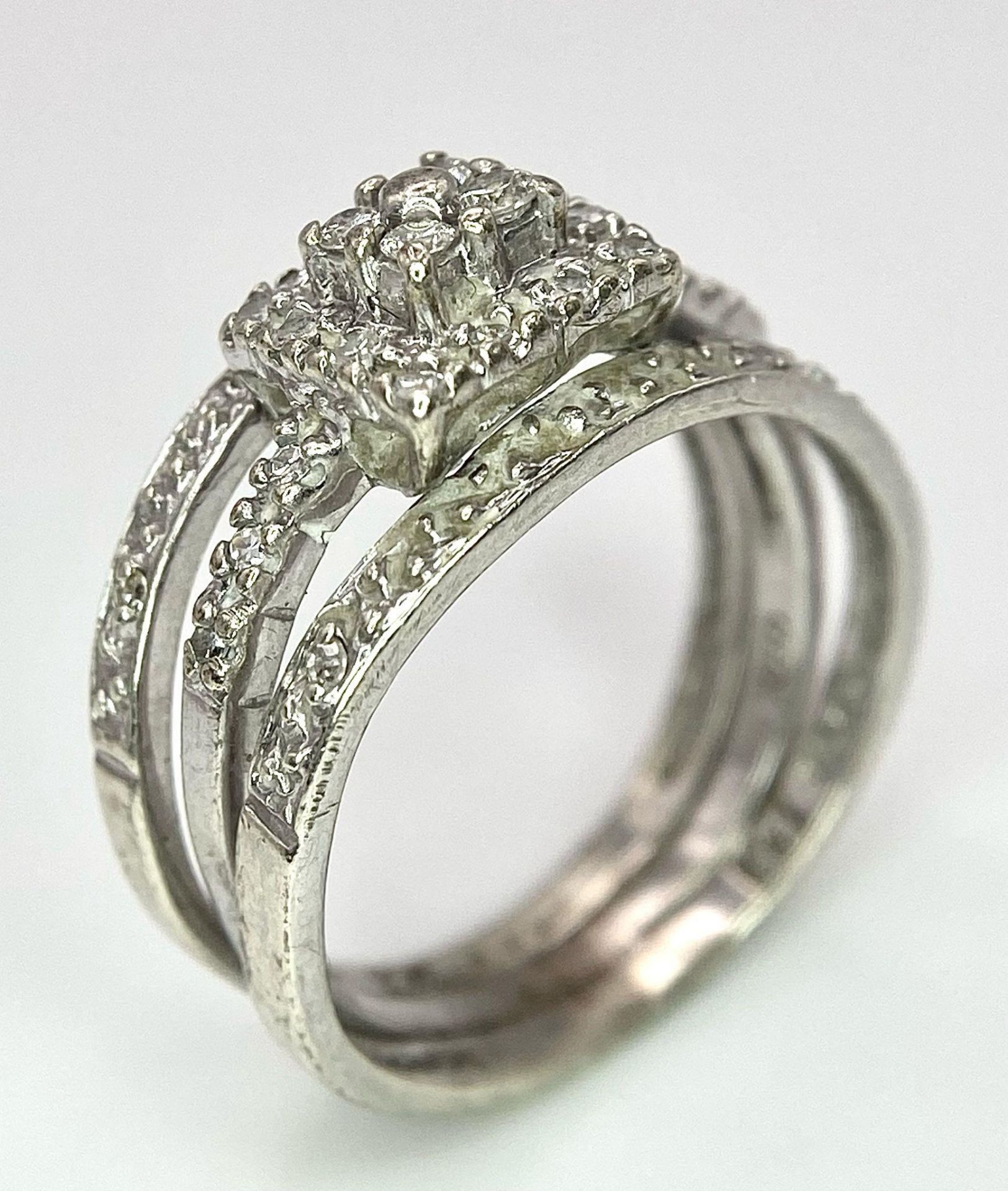 A 9K White Gold Diamond Three-Level Cluster Ring. Size I. 3.7g total weight.