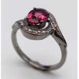 A Garnet and Diamond Ring set in 925 Silver with a Black Rhodium coating. Oval cut Garnet- 0.80ct.