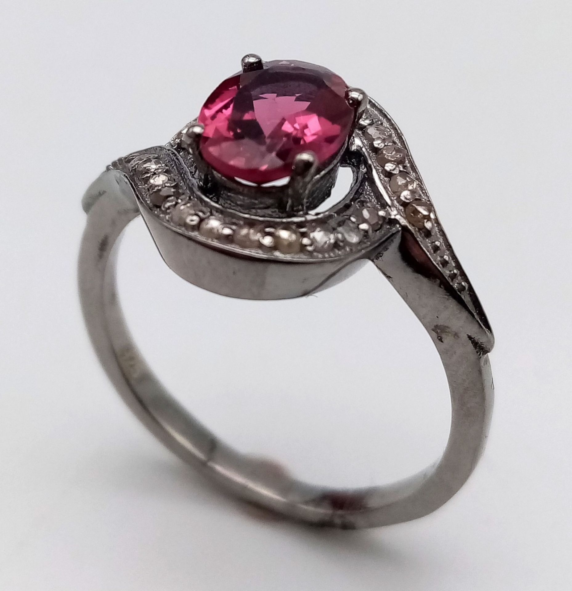 A Garnet and Diamond Ring set in 925 Silver with a Black Rhodium coating. Oval cut Garnet- 0.80ct.