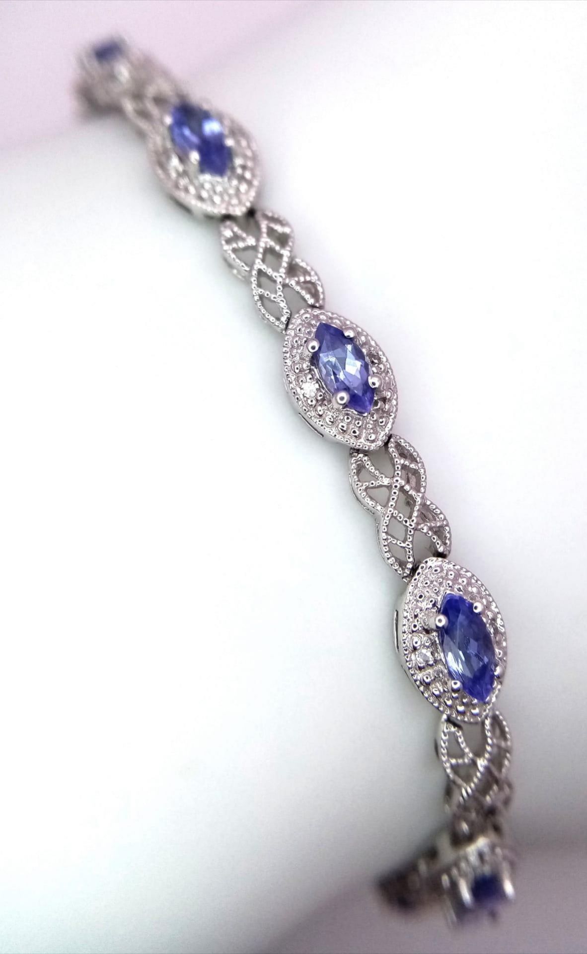 A 9K White Gold, Purple Sapphire and Diamond Tennis Bracelet. Eye-shaped links with sapphire