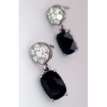 A Pair of 18K Diamond and Onyx Earrings. Diamond clusters and rectangular cut onyx. No backs. With