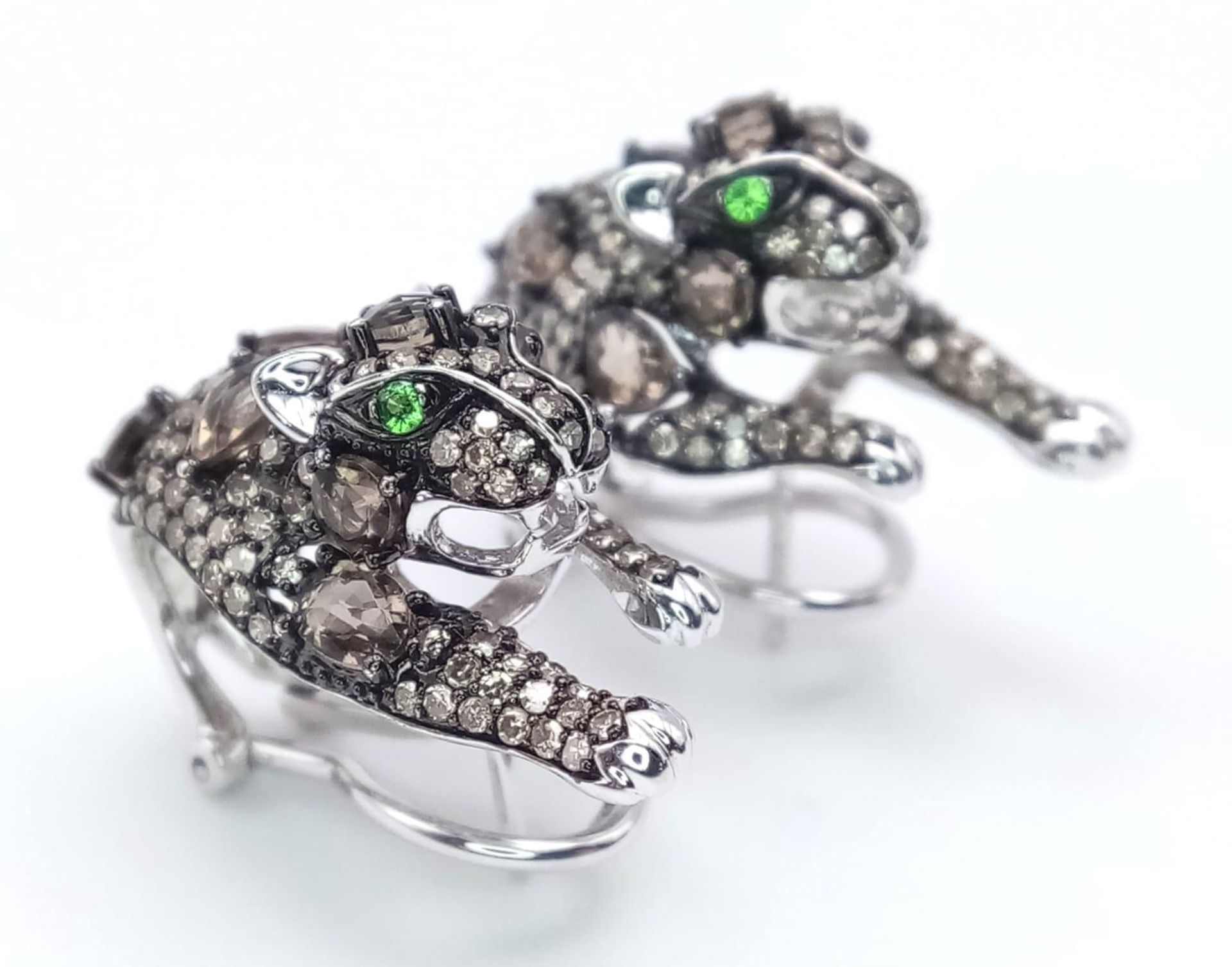 A STUNNING PAIR OF 14K WHITE GOLD DIAMOND , CHAMPAGNE DIAMONDS AND EMERALD PANTHER EARRINGS. 10.5gms