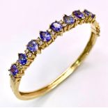 An Alluring 14K Yellow Gold, Amethyst and Diamond Bangle. High-grade, clean pear-cut amethysts