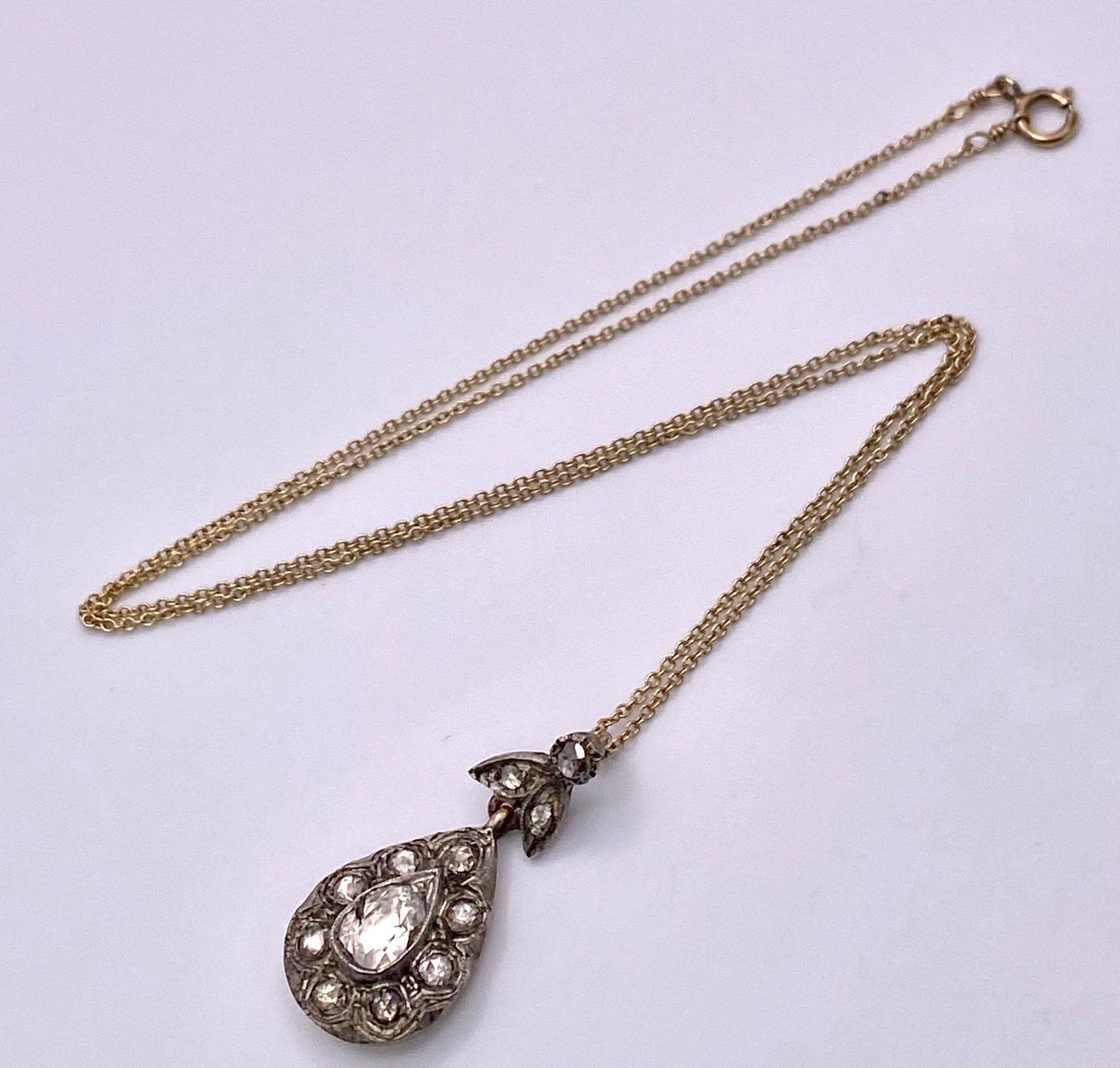 A 14K Yellow Gold Necklace with a Diamond Set Pendant. Pendant measures 2.5cm in length and features