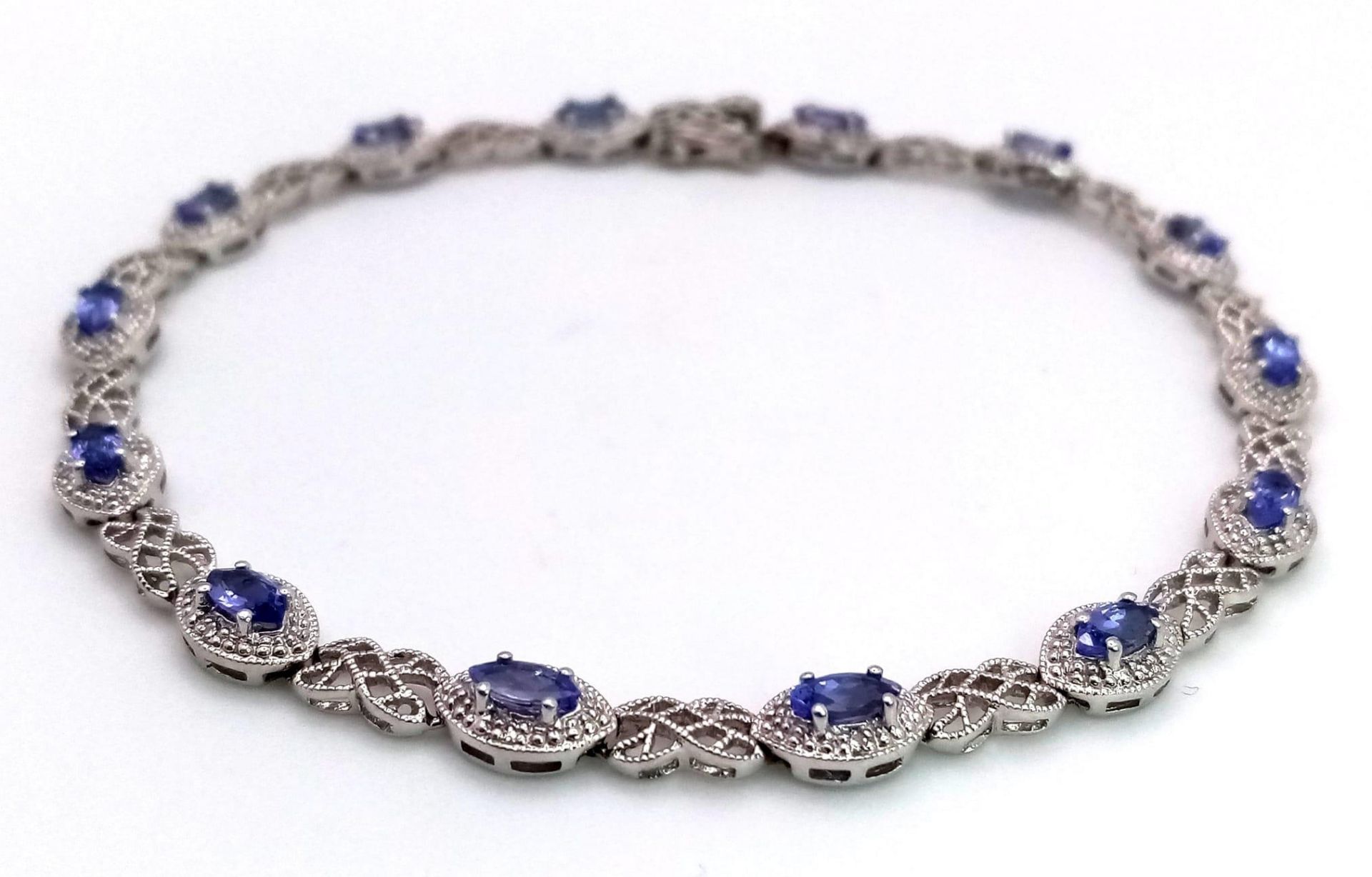 A 9K White Gold, Purple Sapphire and Diamond Tennis Bracelet. Eye-shaped links with sapphire - Image 2 of 5