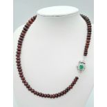 A 260ctw Garnet Rondelle Gemstone Necklace with Emerald Clasp - Set in 925 Silver. 44cm length. 53.