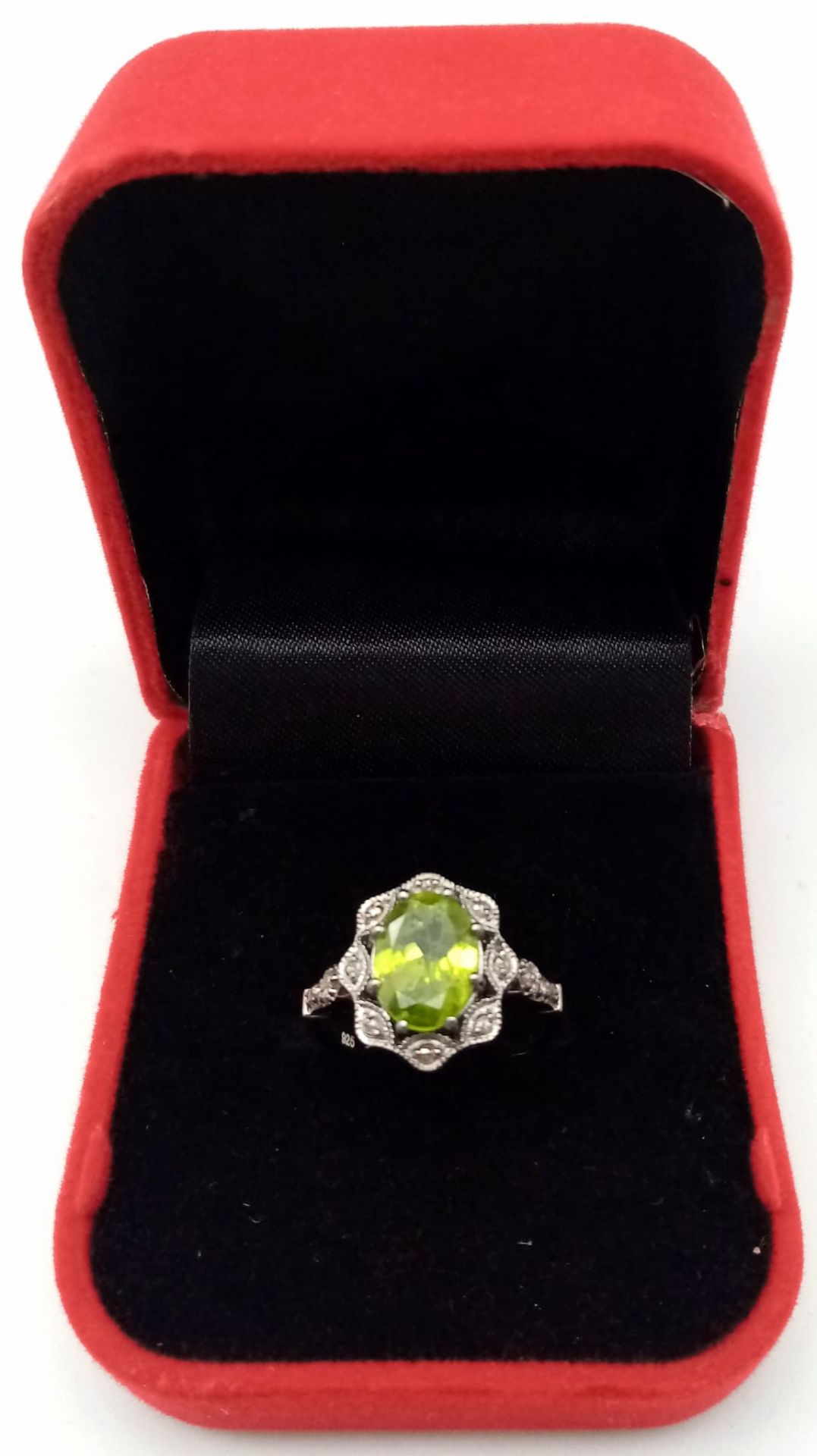 A Peridot and Diamond 925 Silver Ring. Central 2.50ct oval peridot with a diamond surround - 0. - Image 4 of 6