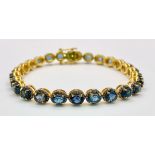 A Kyanite Tennis Bracelet with Diamond Accents on Gilded 925 Silver. Approximately 8ctw kyanites,