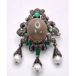 A Scintillating Opal, Emerald & Diamond, Sterling Silver (tested) Brooch. The central 6.10ct opal