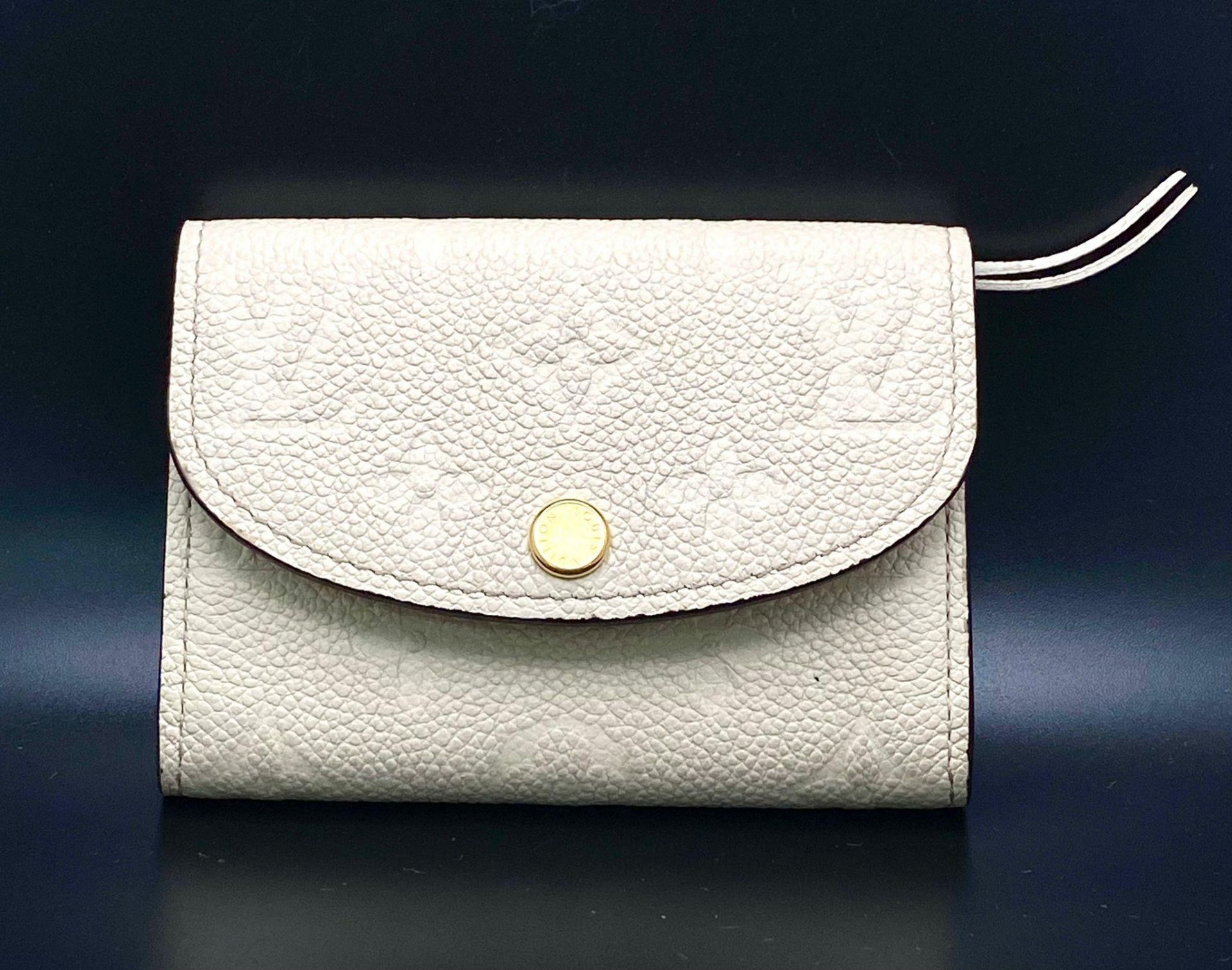 A Louis Vuitton Beige Leather Purse/Wallet. Decorative monogram exterior. Zipped inner