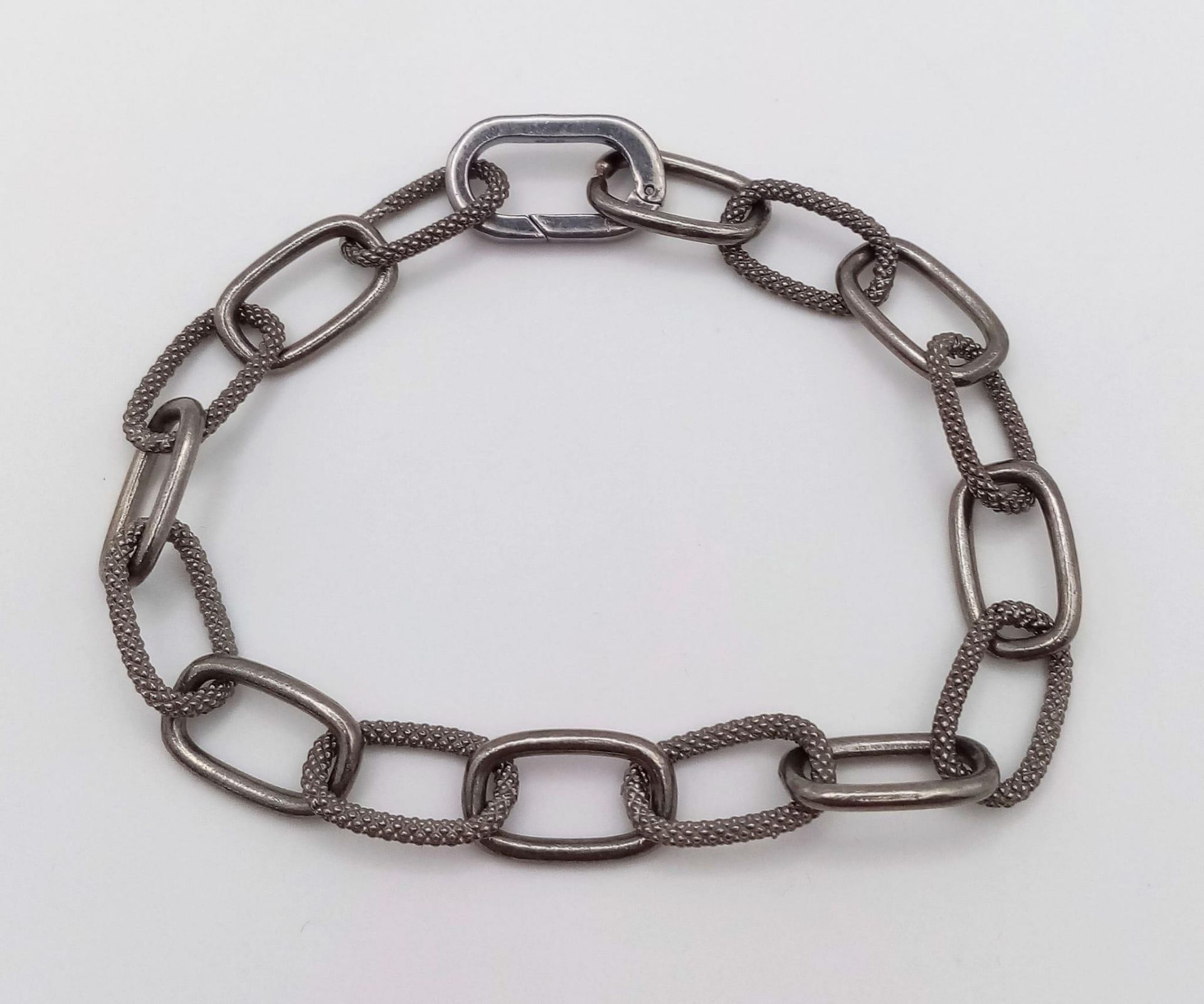 A 925 Silver Elongated Link Bracelet with a Black Rhodium Coating. Weight - 13.50g. 18cm length.