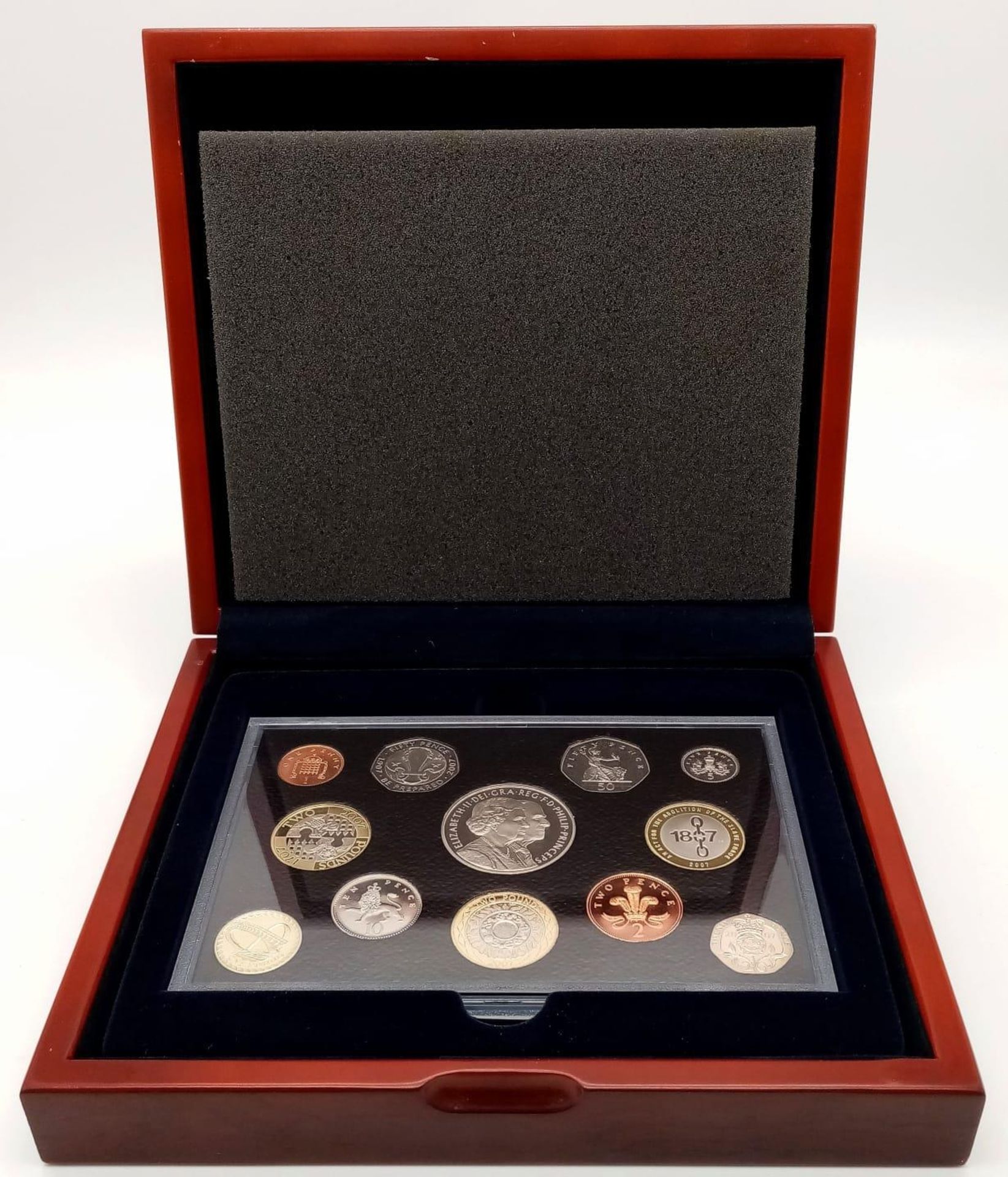 A Royal Mint 2007 Executive Proof Coin Set. 12 coins in total. Comes in a wood presentation case.
