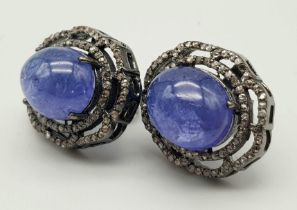 A Pair of Pale Blue Tanzanite Cabochon Gemstone Earrings with Diamond Surrounds set in 925 Silver.