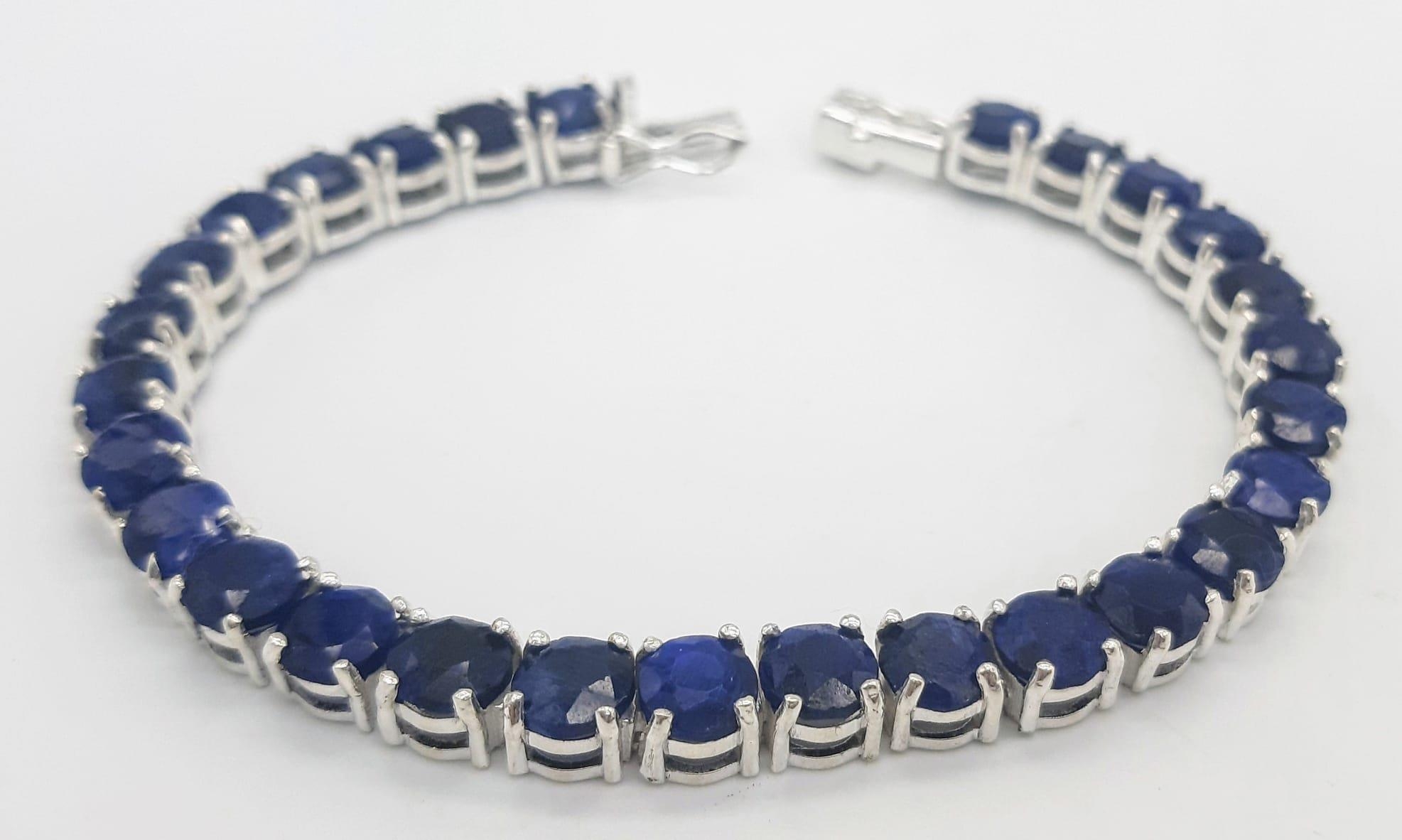 A Blue Sapphire Gemstone Tennis Bracelet set in 925 Silver. 18cm length. 19.75g total weight. Ref: - Image 4 of 5