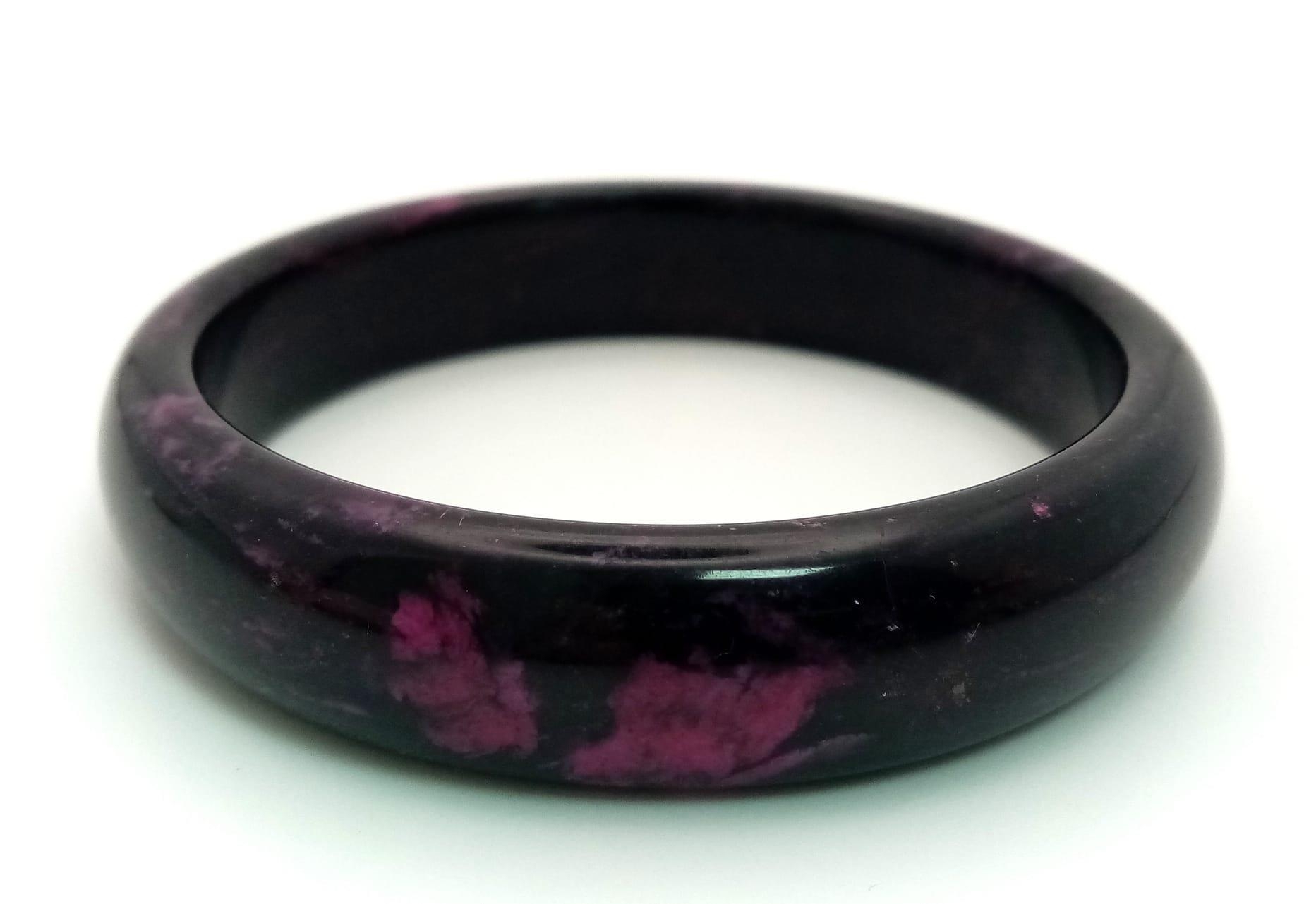 A Shades of Purple Jade Bangle. 6cm inner diameter. 14mm width.