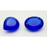 Two Bright Blue Gemstones - 65ctw. No certificates so as found.