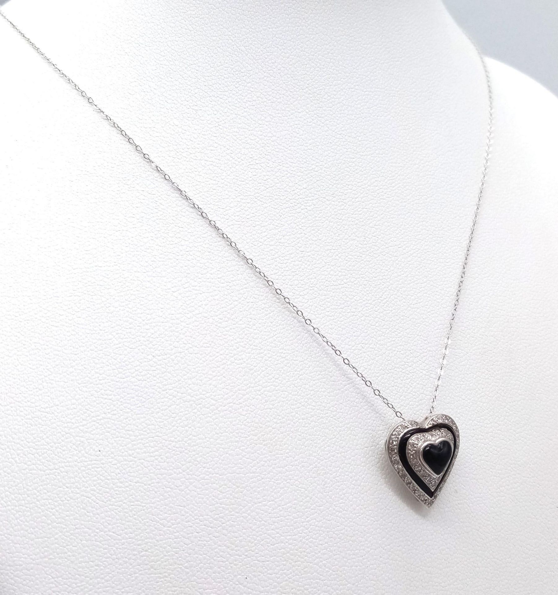 An 18K White Gold Diamond and Black Onyx Heart Pendant on a 9K White Gold Disappearing Necklace. - Image 3 of 6
