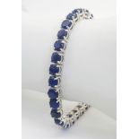 A Blue Sapphire Gemstone Tennis Bracelet set in 925 Silver. 18cm length. 19.75g total weight. Ref: