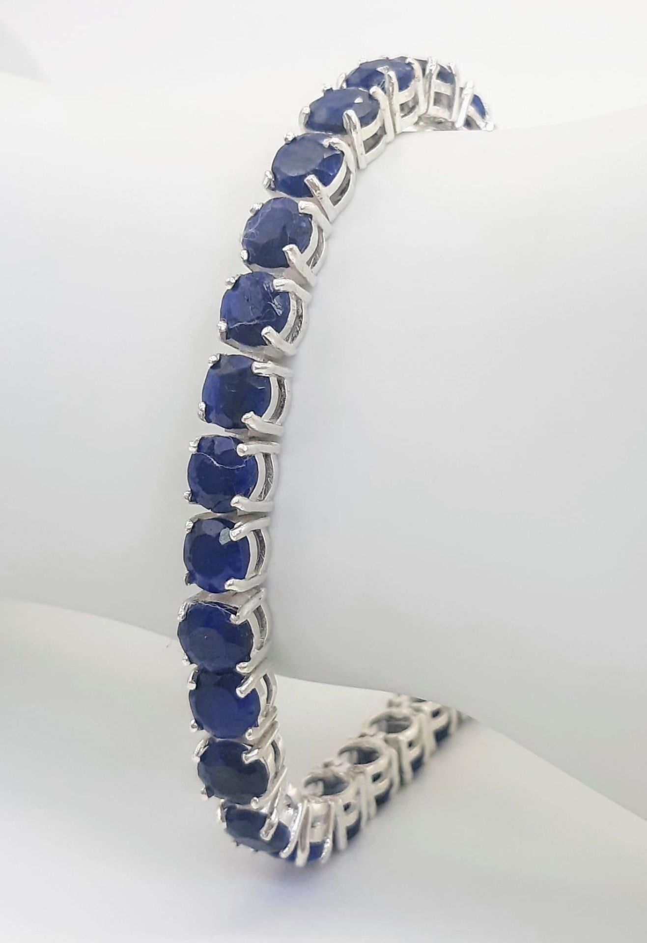 A Blue Sapphire Gemstone Tennis Bracelet set in 925 Silver. 18cm length. 19.75g total weight. Ref: