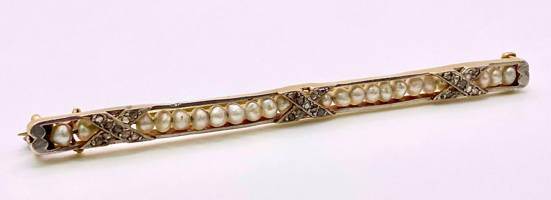 An Antique Mid-Karat Gold, Pearl and Diamond Bar Brooch. 6.5cm length. 5.24g total weight.