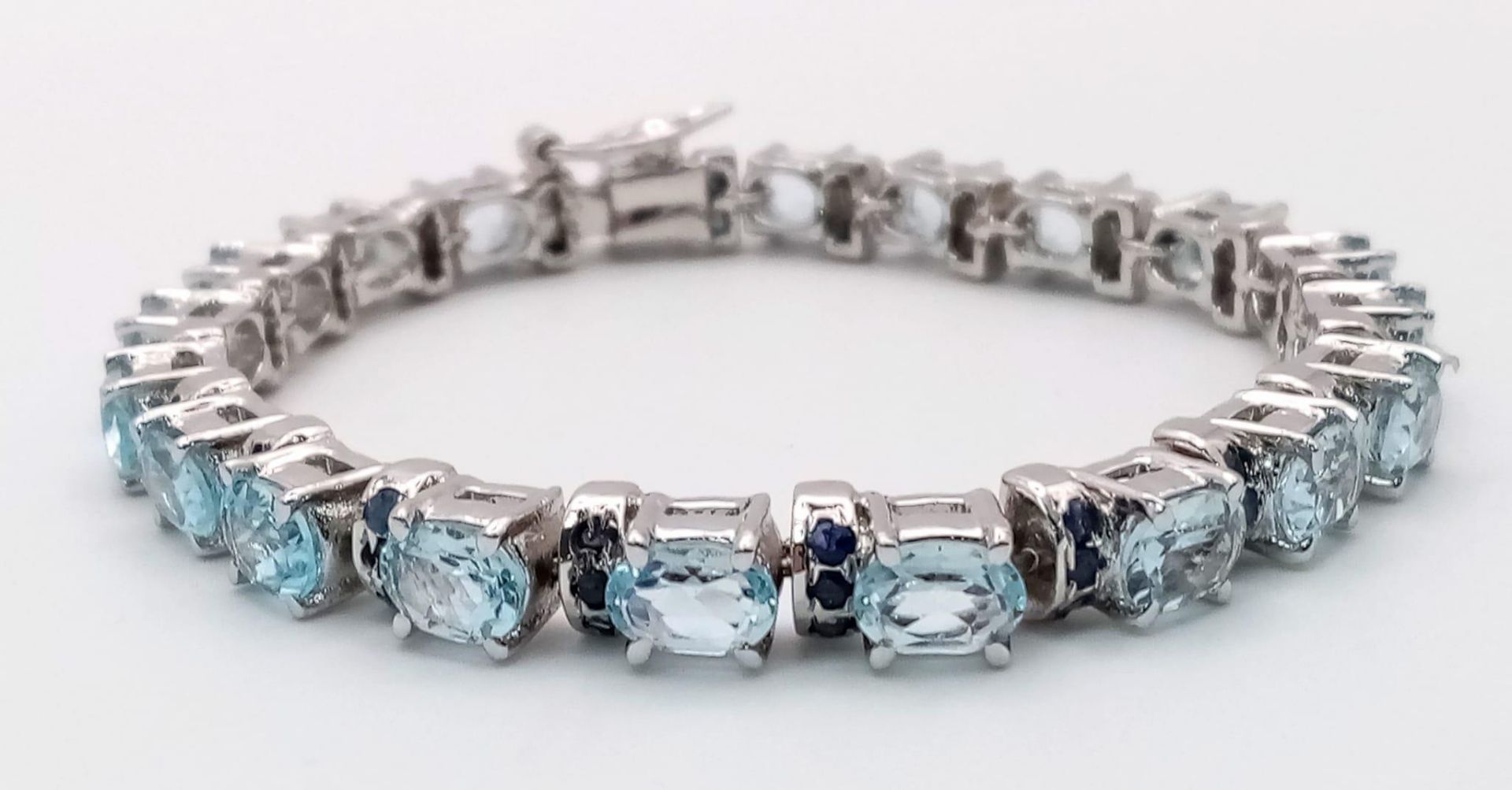 An Aquamarine Gemstone Tennis Bracelet set in 925 Silver. 18cm length. 28g. Ref: HV -2177