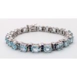 An Aquamarine Gemstone Tennis Bracelet set in 925 Silver. 18cm length. 28g. Ref: HV -2177