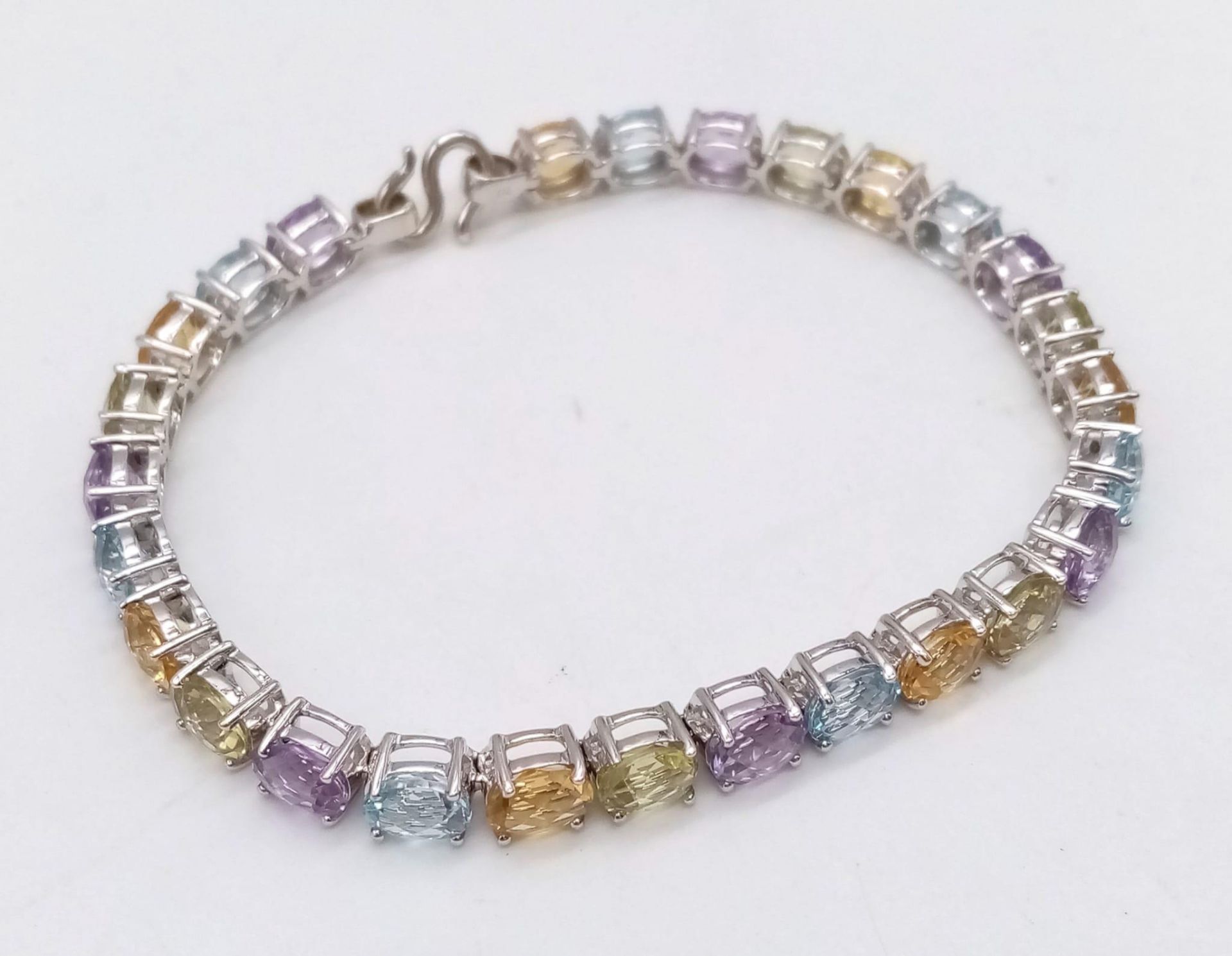 A 9K White Gold Multi-Gemstone Tennis Bracelet. Includes beautifully oval-cut faceted amethyst, - Image 2 of 6