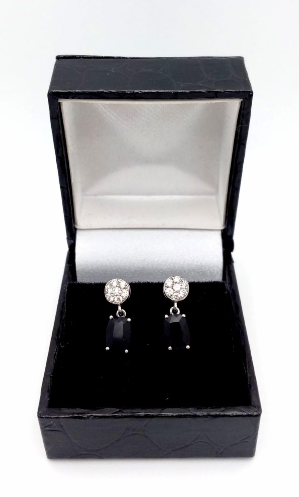 A Pair of 18K Diamond and Onyx Earrings. Diamond clusters and rectangular cut onyx. No backs. With - Image 4 of 4