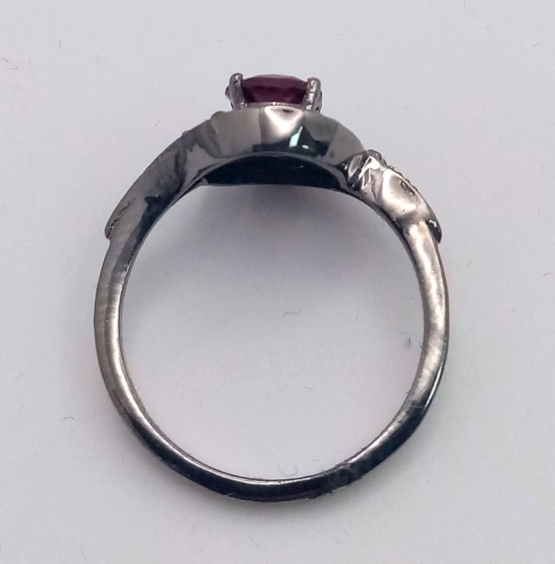 A Garnet and Diamond Ring set in 925 Silver with a Black Rhodium coating. Oval cut Garnet- 0.80ct. - Image 5 of 7