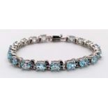 An Ice Blue Topaz Gemstone Tennis Bracelet set in 925 Silver. Weight - 25.30g. 18cm length. Ref: