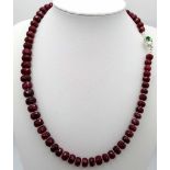 A 280ctw Faceted Ruby Rondelle Necklace with Emerald and Diamond 925 Silver clasp. 44cm length.