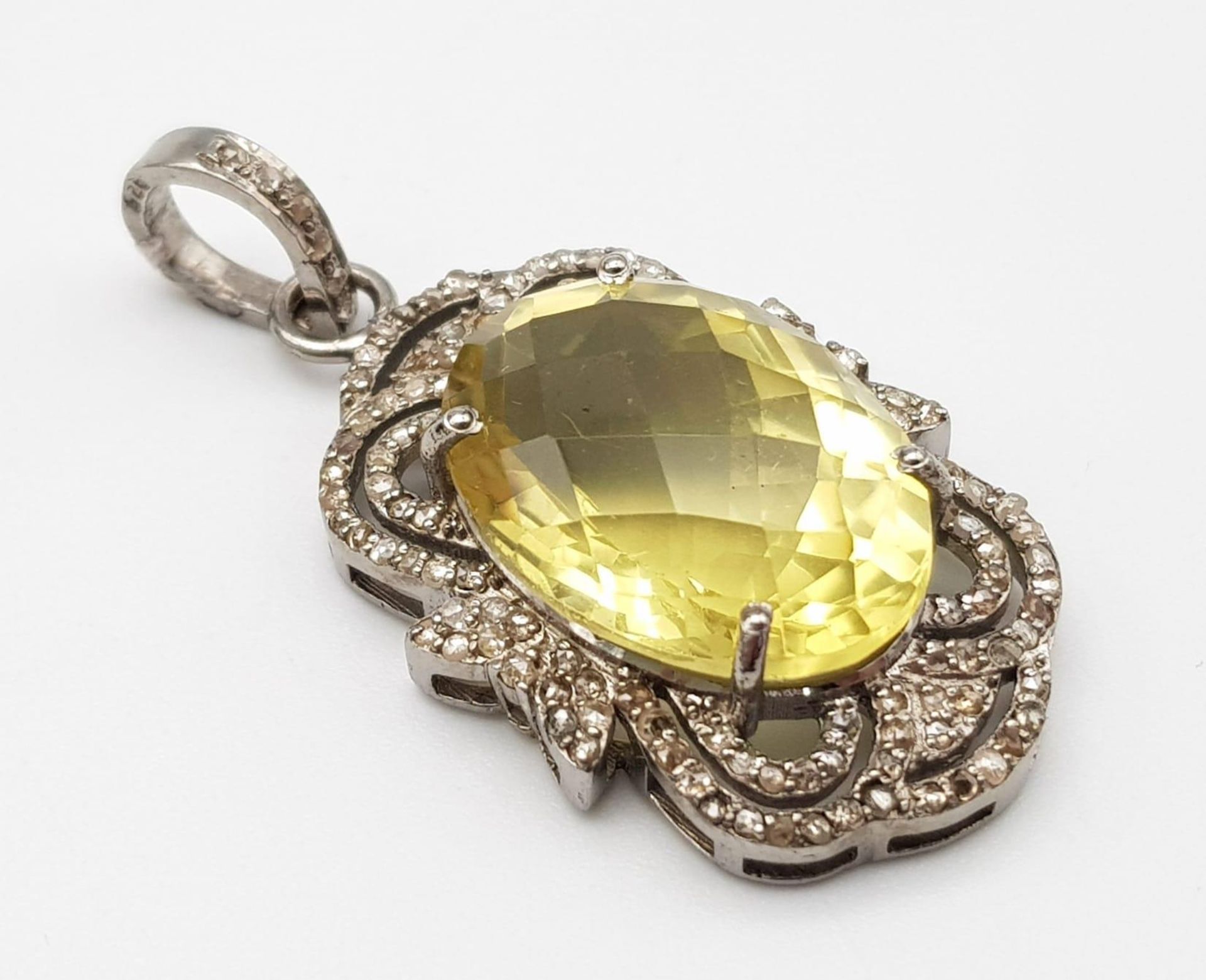 An Oval Faceted Lemon Quartz and Diamond Art Deco Style Pendant set in 925 Silver. 4cm. Weight - 7.