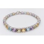 A 9K White Gold Multi-Gemstone Tennis Bracelet. Includes beautifully oval-cut faceted amethyst,