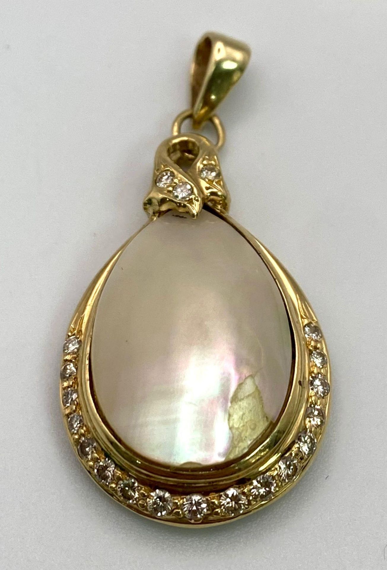 An 18K Yellow Gold, Diamond and Mother of Pearl Pendant. Teardrop Mother of Pearl cabochon with