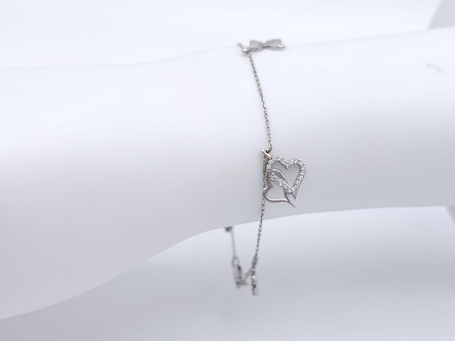 A 14kt White Gold Diamond Set Charm Bracelet. Variety of charms, this bracelet measures 16cm in - Image 5 of 5