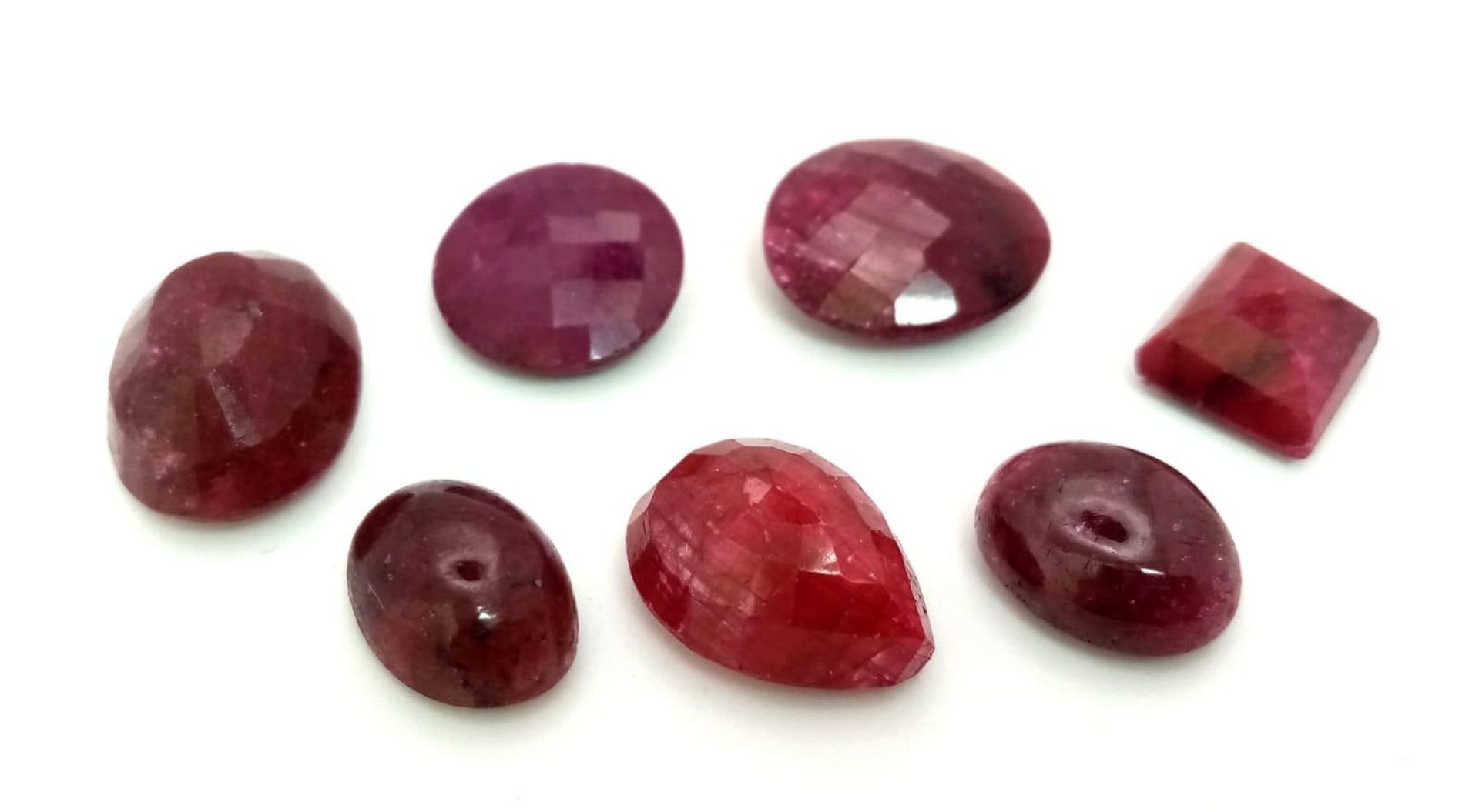 A Lot of 97.5CT Faceted & Cabochon Colour Enhanced Ruby. Mixed Shapes. GLI Certified.
