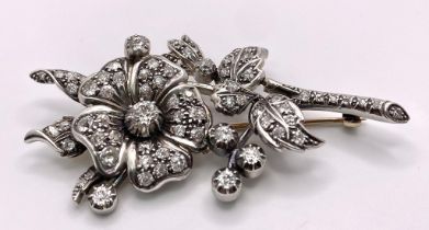 An Antique 18K Gold and Diamond Floral Brooch. This beautifully constructed masterpiece has a