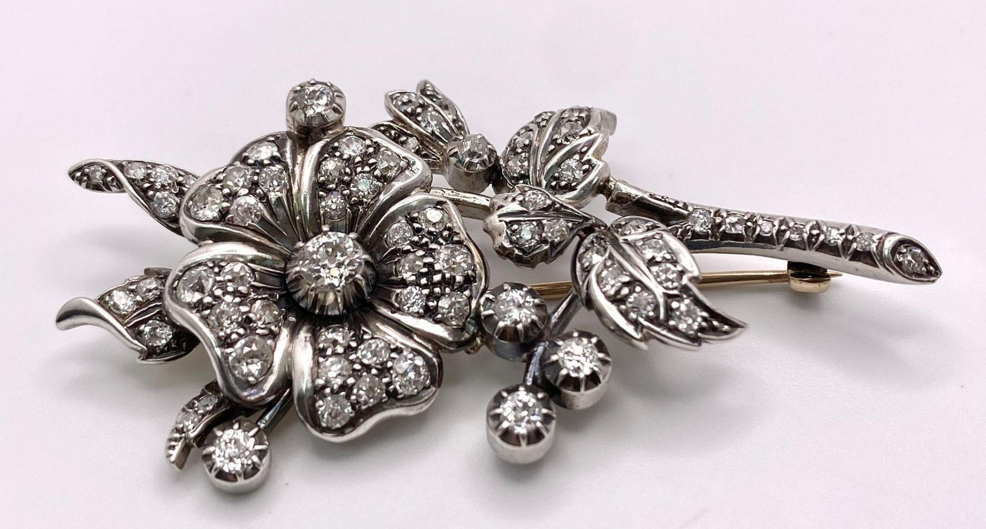 An Antique 18K Gold and Diamond Floral Brooch. This beautifully constructed masterpiece has a