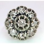 An 18K Yellow and White Gold Diamond Ring. Central brilliant round cut diamond with an eight