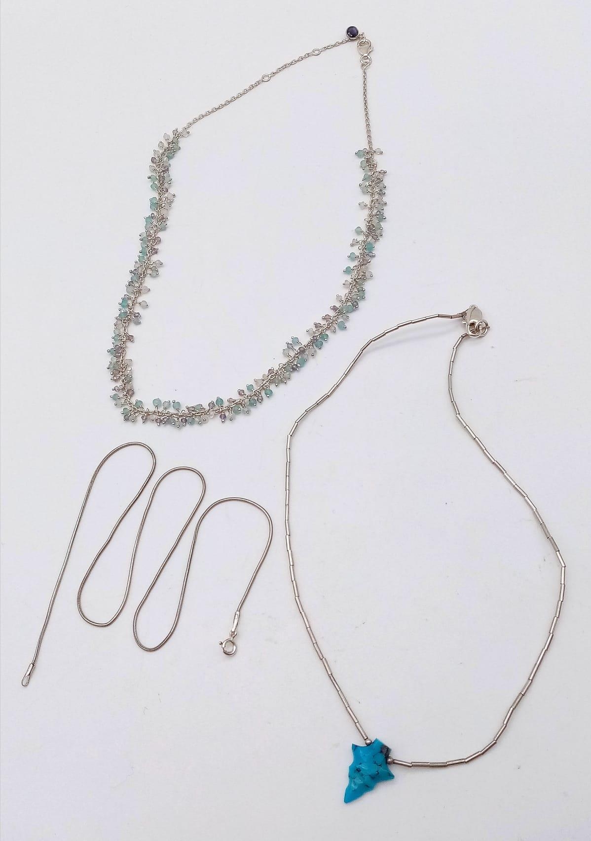 Trio of Sterling Silver Necklaces. One plain necklace, one with a turquoise pendant and the third