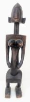 An Antique African Songye Tribe Female Wooden Statue. This fertility and youth statue stands at