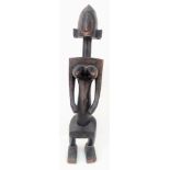 An Antique African Songye Tribe Female Wooden Statue. This fertility and youth statue stands at