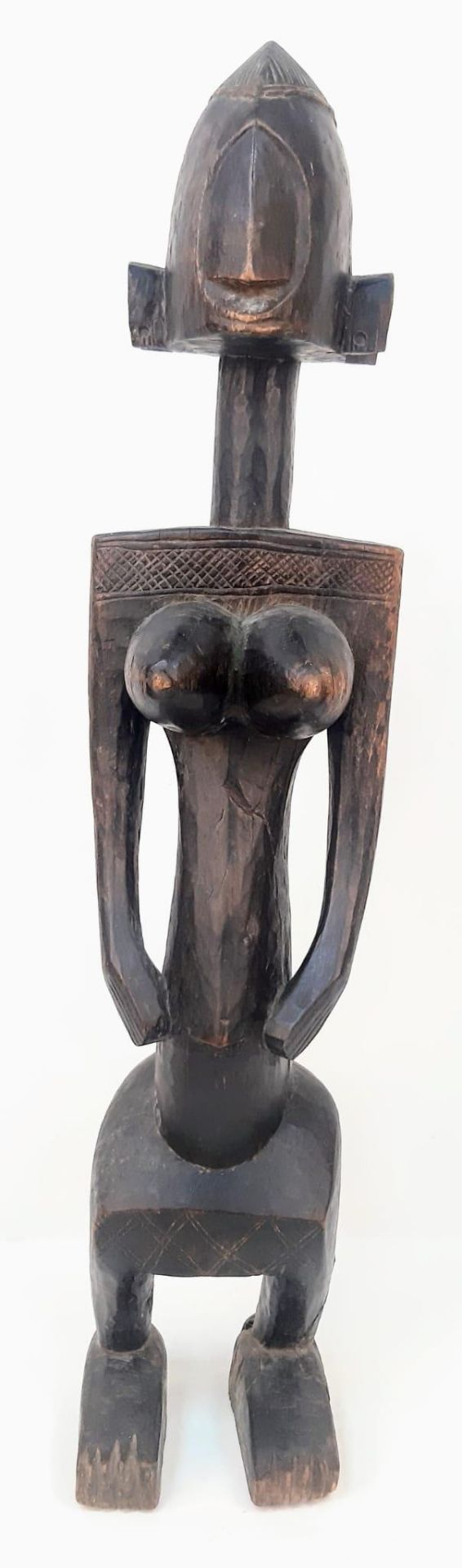 An Antique African Songye Tribe Female Wooden Statue. This fertility and youth statue stands at